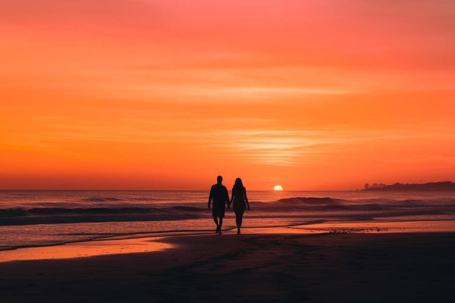 Two people in love walking on beach generated by ai